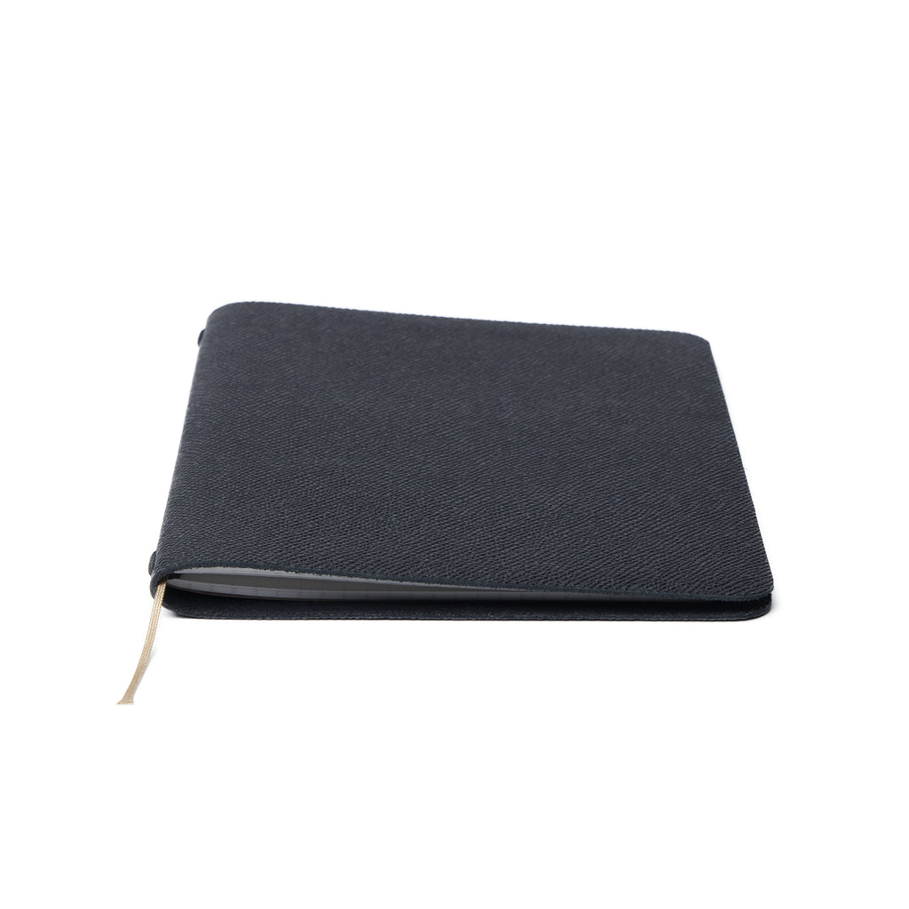 A closed Pensift Notebook in black Italian Epsom leather, showing its minimalist exterior and slim profile.