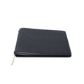 A closed Pensift Notebook in black Italian Epsom leather, showing its minimalist exterior and slim profile.