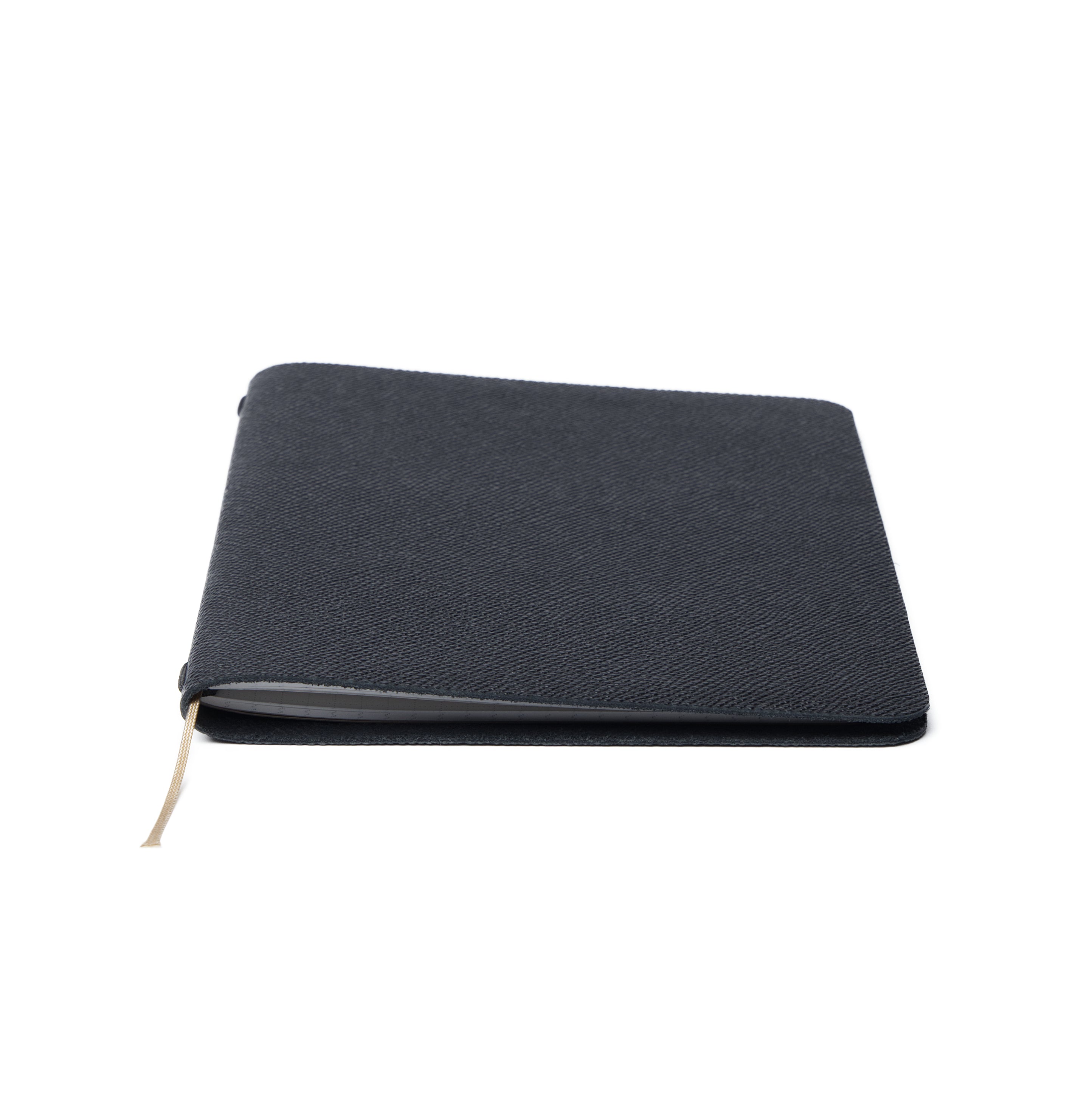 A closed Pensift Notebook in black Italian Epsom leather, showing its minimalist exterior and slim profile.